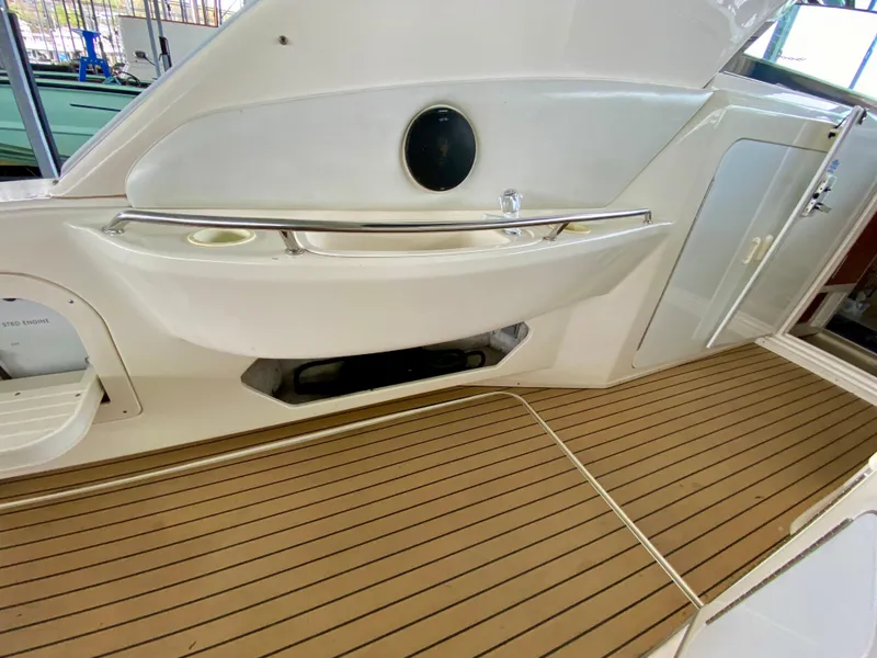 Slide: The Image of 1996 Sea Ray 450 Sundancer boat deck with sleek design and wood-like flooring. - 12