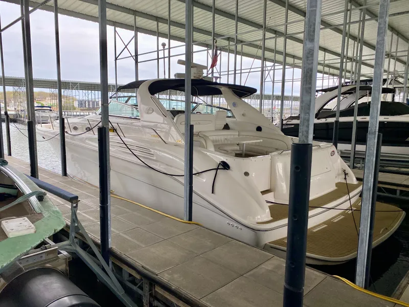 Slide: The Image of 1996 Sea Ray 450 Sundancer yacht docked in a covered marina. - 2