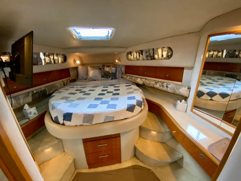 Slide: The Image of Luxurious cabin interior of 1996 Sea Ray 450 Sundancer yacht with cozy bed and elegant decor. - 20