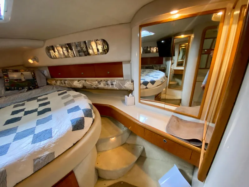 Slide: The Image of Luxurious 1996 Sea Ray 450 Sundancer cabin with cozy bed and elegant wood finishes. - 21