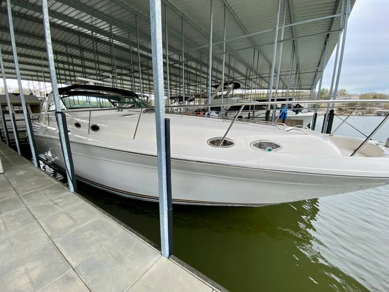 Slide: The Image of 1996 Sea Ray 450 Sundancer docked in a covered marina. - 3