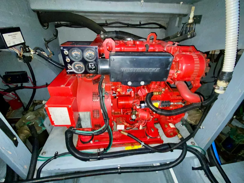 Slide: The Image of Engine compartment of a 1996 Sea Ray 450 Sundancer with red machinery and control panel. - 31