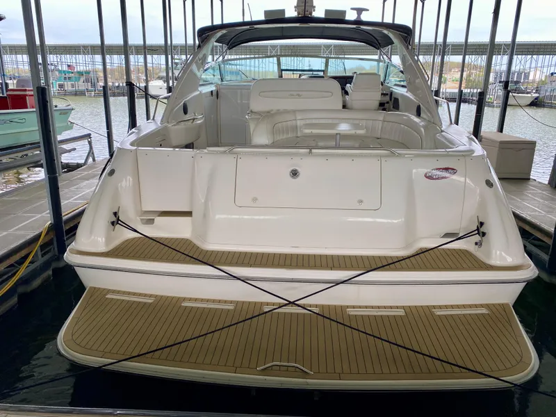 Slide: The Image of 1996 Sea Ray 450 Sundancer yacht docked, showcasing spacious deck and seating area. - 5