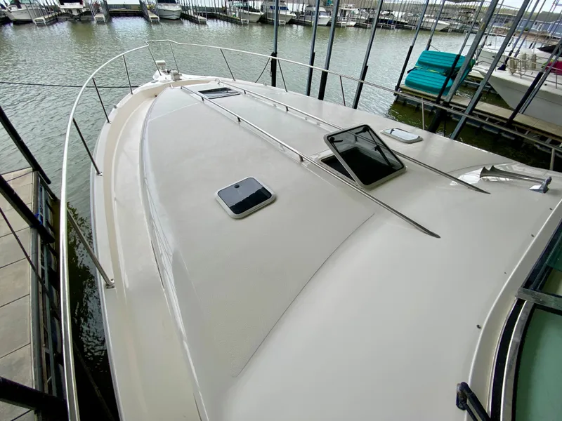 Slide: The Image of 1996 Sea Ray 450 Sundancer yacht docked at marina, top deck view. - 6