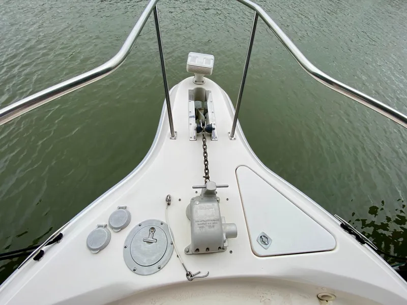 Slide: The Image of Bow of 1996 Sea Ray 450 Sundancer with anchor and railing over water. - 7