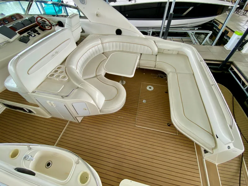 Slide: The Image of 1996 Sea Ray 450 Sundancer interior with white leather seating and wooden flooring. - 8