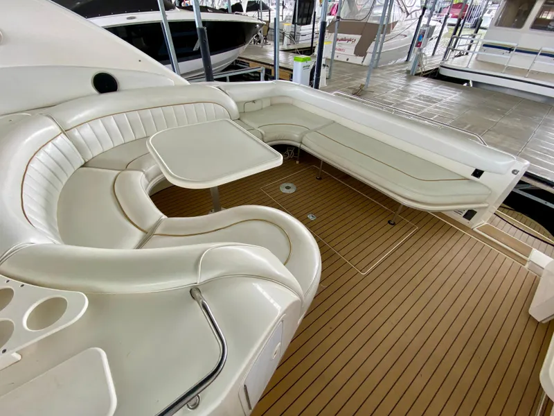 Slide: The Image of 1996 Sea Ray 450 Sundancer boat with white seating and wooden deck. - 9