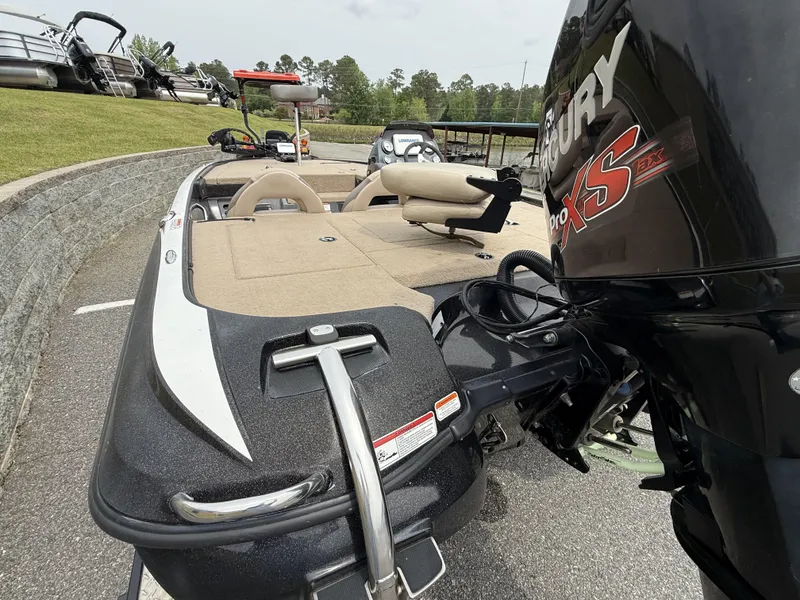 Slide: The Image of 2014 Nitro Z-7 boat with Mercury Pro XS engine, parked on pavement. - 3
