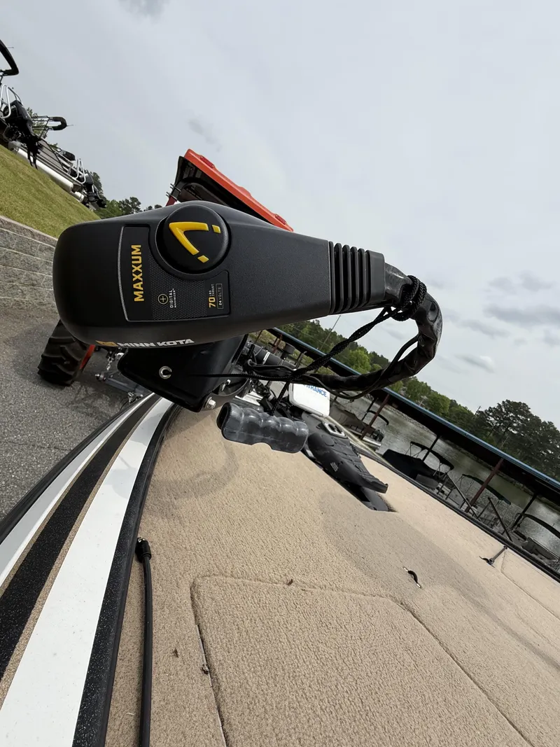 Slide: The Image of Trolling motor on a 2014 Nitro Z-7 boat, docked near a lake. - 4