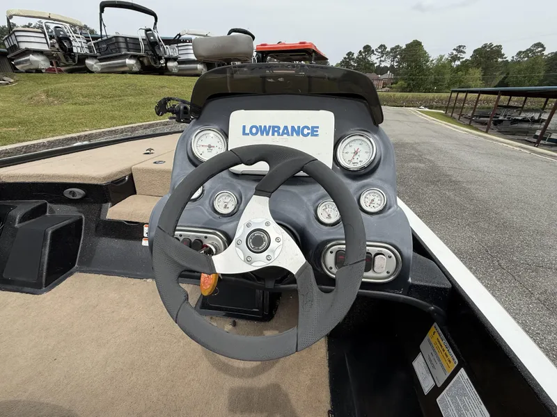 Slide: The Image of Steering wheel and dashboard of a 2014 Nitro Z-7 boat with gauges and Lowrance display. - 6