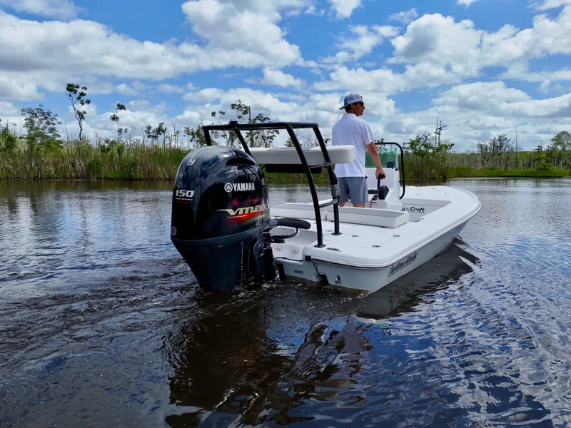 Slide: The Image of 2025 Action Craft 17 Flats boat with Yamaha engine on a calm waterway. - 26