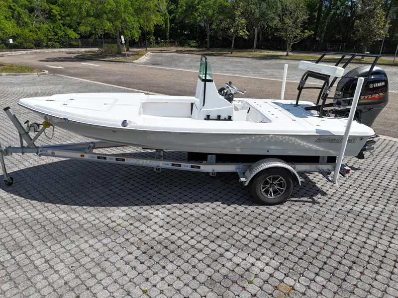 Slide: The Image of 2025 Action Craft 17 Flats boat on trailer, parked outdoors. - 34