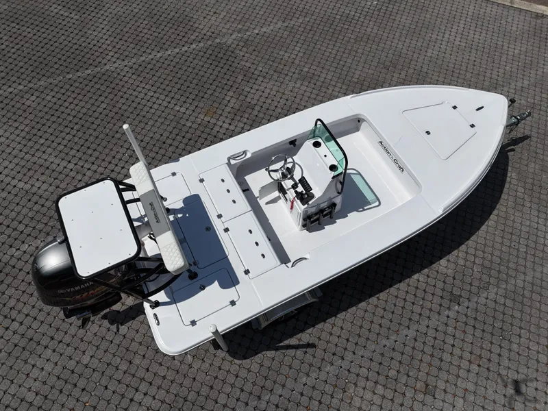 Slide: The Image of 2025 Action Craft 17 Flats boat, aerial view, on a paved surface. - 36