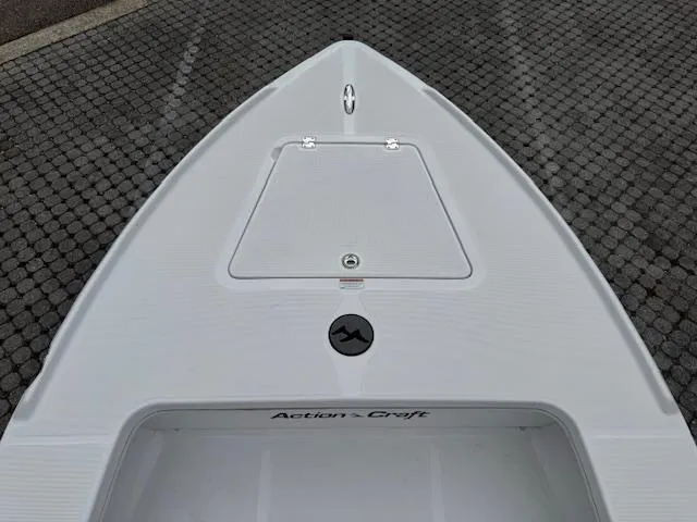 Slide: The Image of Bow view of 2025 Action Craft 17 Flats boat on cobblestone surface. - 41