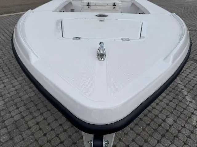 Slide: The Image of 2025 Action Craft 17 Flats boat, white hull, on a cobblestone surface. - 42