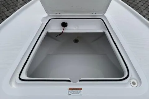 Slide: The Image of Open storage compartment on 2025 Action Craft 17 Flats boat, showcasing interior space. - 43