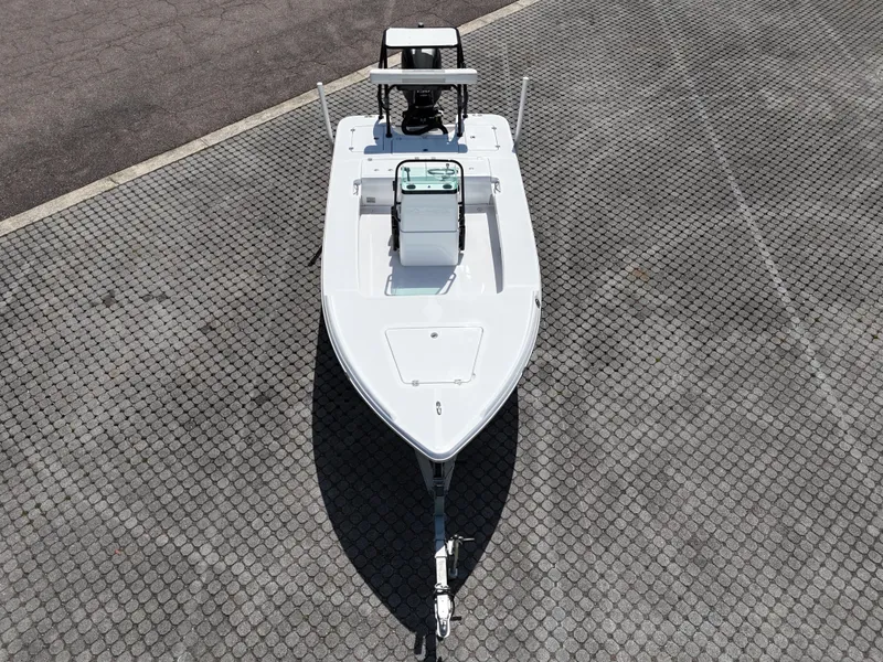 Slide: The Image of 2025 Action Craft 17 Flats boat on paved surface, aerial view. - 56