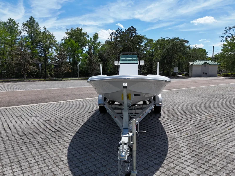 Slide: The Image of 2025 Action Craft 17 Flats boat on trailer in sunny outdoor setting. - 57