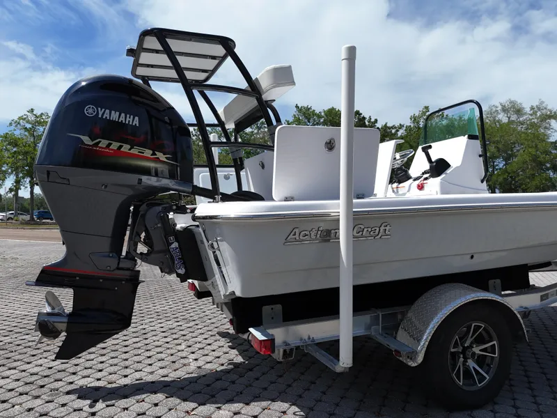Slide: The Image of 2025 Action Craft 17 Flats boat with Yamaha engine on a trailer, parked outdoors. - 66