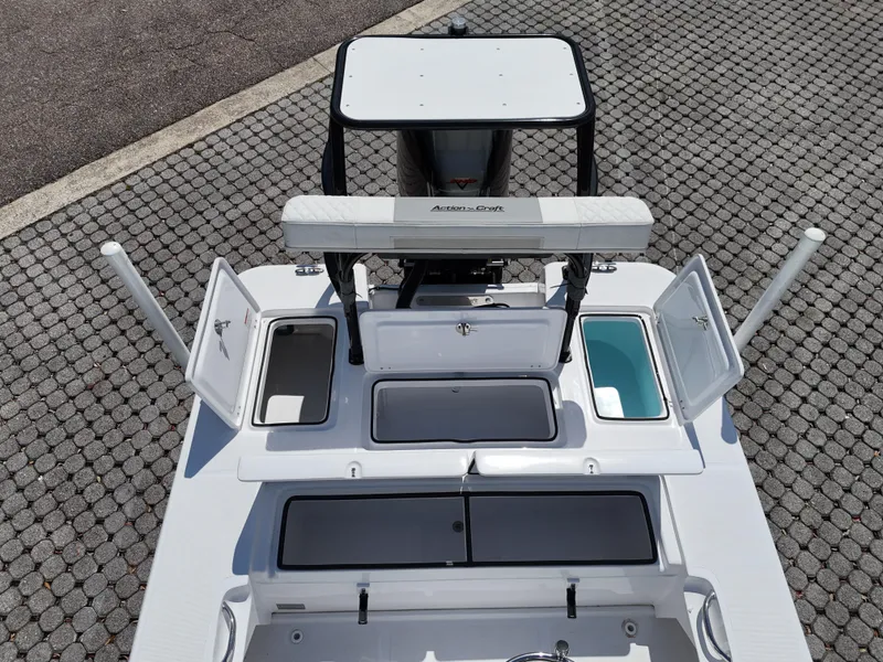 Slide: The Image of 2025 Action Craft 17 Flats boat with open storage compartments, viewed from above. - 67