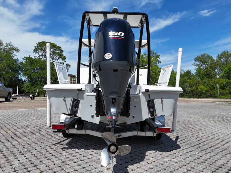 Slide: The Image of 2025 Action Craft 17 Flats boat with powerful 150 HP engine, parked on paved surface. - 69