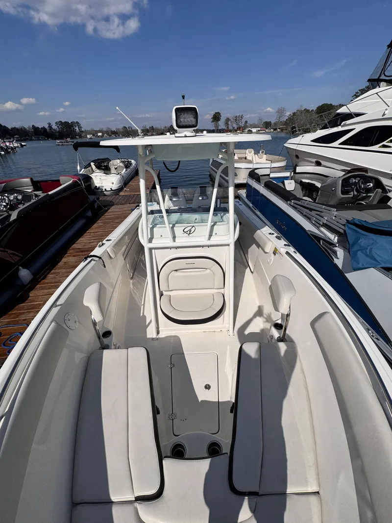 Slide: The Image of 2023 Sailfish 242 CC boat docked, featuring spacious seating and modern design. - 10
