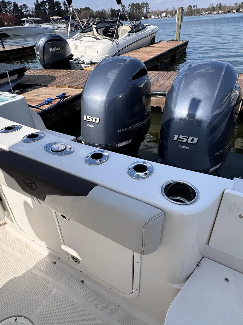 Slide: The Image of 2023 Sailfish 242 CC boat with twin Yamaha 150 engines docked at marina. - 4