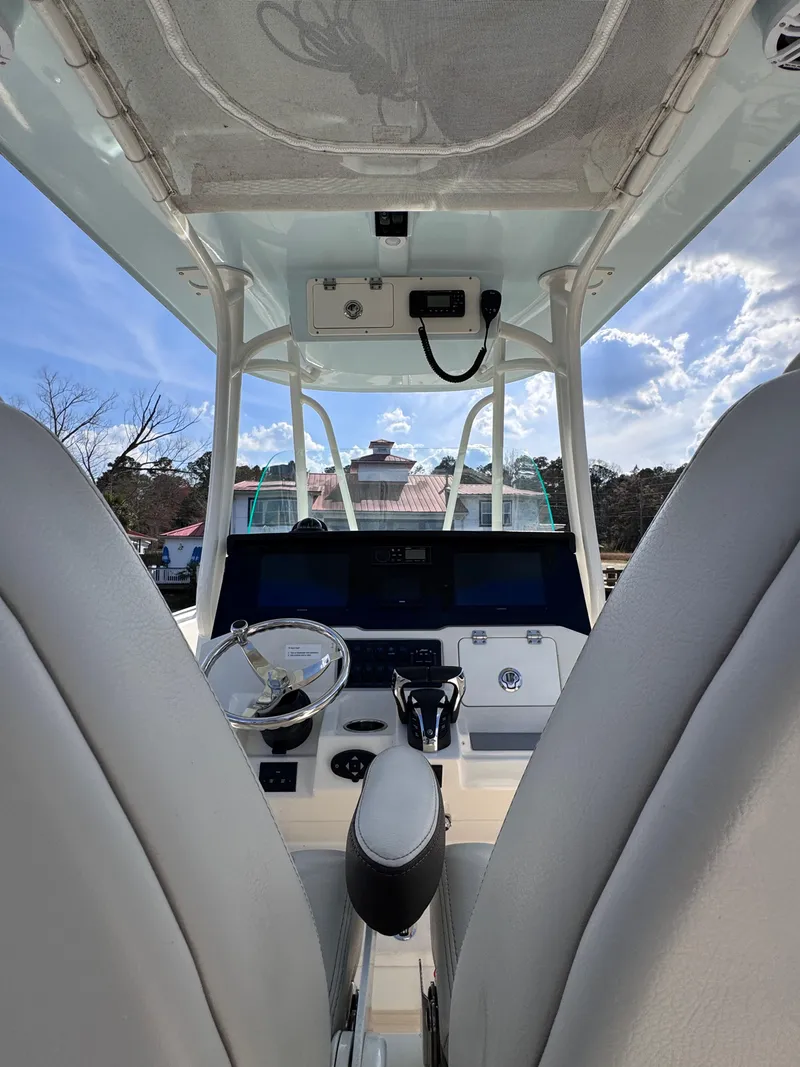 Slide: The Image of 2023 Sailfish 242 CC boat interior with steering wheel and control panel. - 5