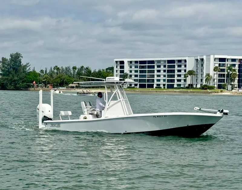 The Image of 2022 ZCB 26 Freemason boat cruising on water near modern waterfront buildings. - 0