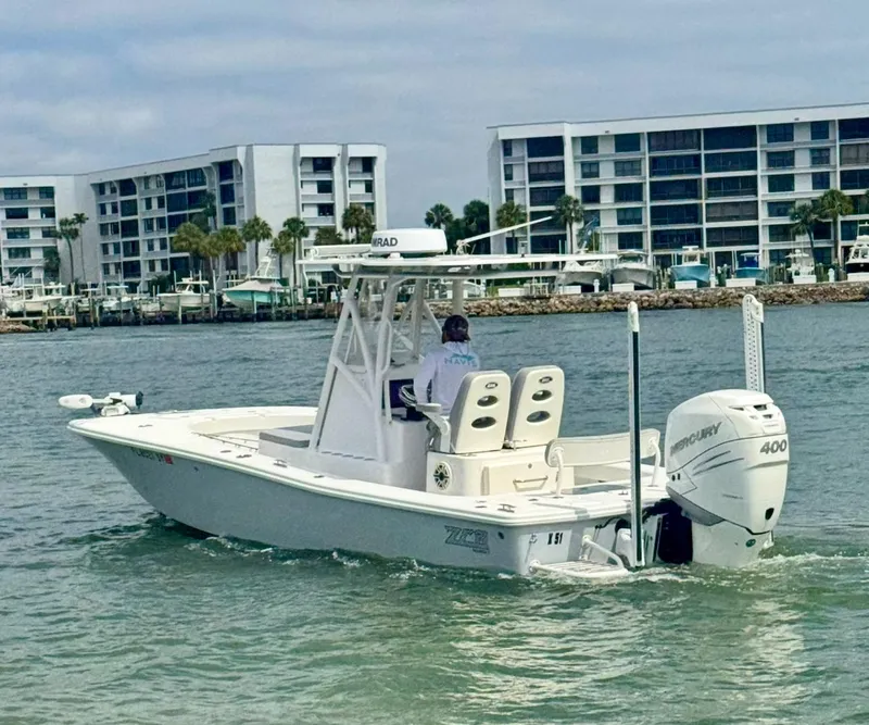 Slide: The Image of 2022 ZCB 26 Freemason boat cruising near modern waterfront buildings. - 10