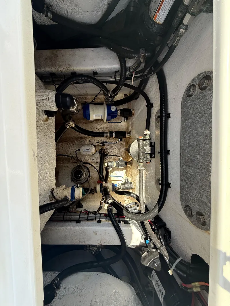 Slide: The Image of Engine compartment of a 2022 ZCB 26 Freemason boat, showcasing wiring and components. - 12