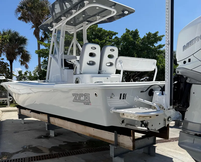 Slide: The Image of 2022 ZCB 26 Freemason boat on display with dual seats and Mercury engine. - 13