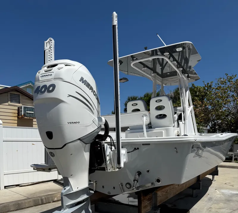 Slide: The Image of 2022 ZCB 26 Freemason boat with Mercury 400 engine, docked outdoors. - 14