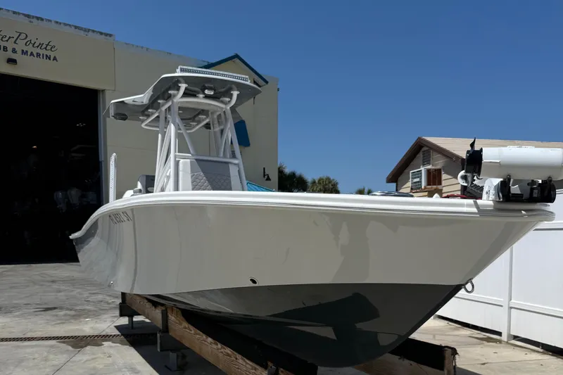 Slide: The Image of 2022 ZCB 26 Freemason boat docked at marina under clear blue sky. - 15
