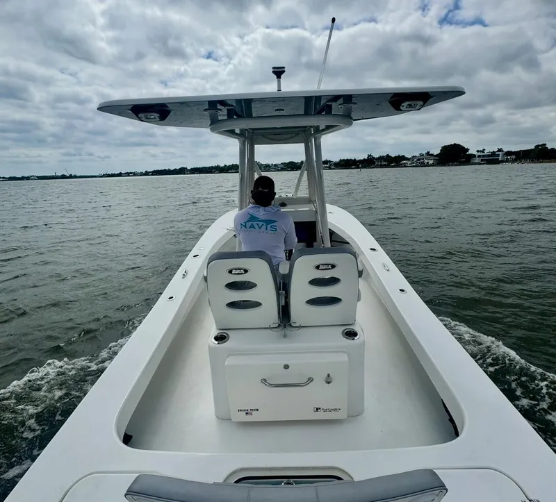 Slide: The Image of 2022 ZCB 26 Freemason boat cruising on a calm lake under cloudy skies. - 4
