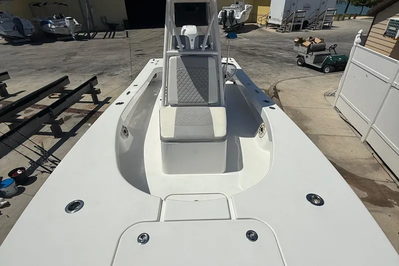 Slide: The Image of 2022 ZCB 26 Freemason boat with spacious deck and seating, docked at a marina. - 5