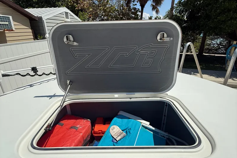Slide: The Image of Open storage compartment on 2022 ZCB 26 Freemason boat with gear inside. - 6