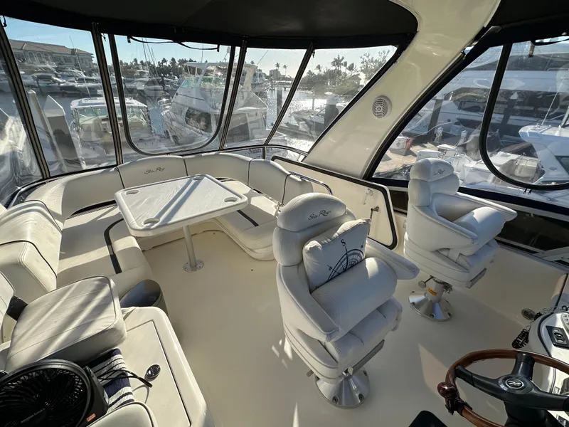 Slide: The Image of 2005 Sea Ray 420 Sedan Bridge interior with seating and helm, showcasing luxury yacht design. - 10