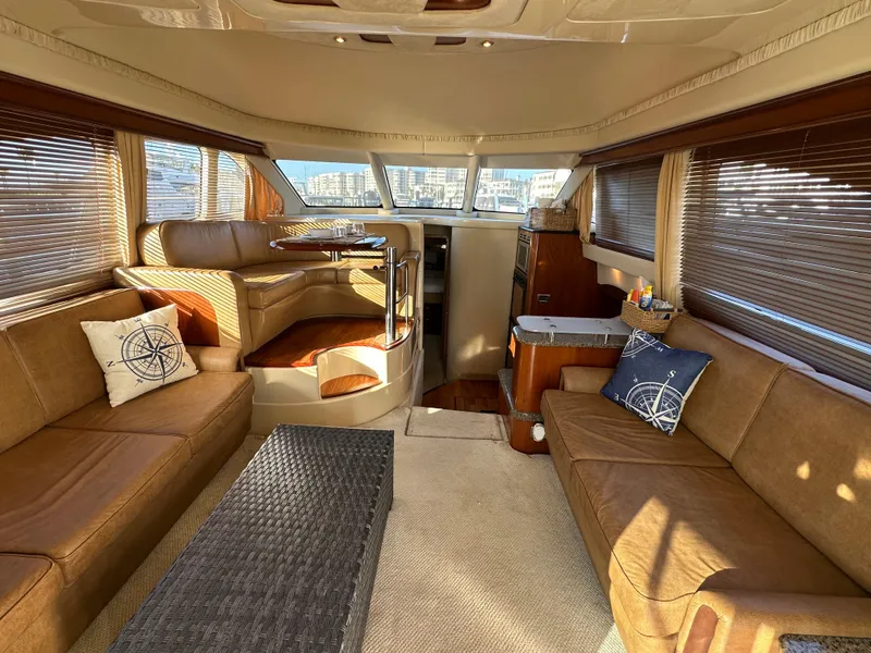 Slide: The Image of Luxurious interior of 2005 Sea Ray 420 Sedan Bridge yacht with elegant seating and decor. - 11