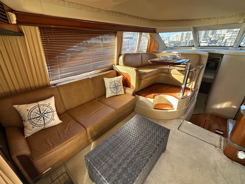 Slide: The Image of Interior of 2005 Sea Ray 420 Sedan Bridge with cozy seating and nautical decor. - 12