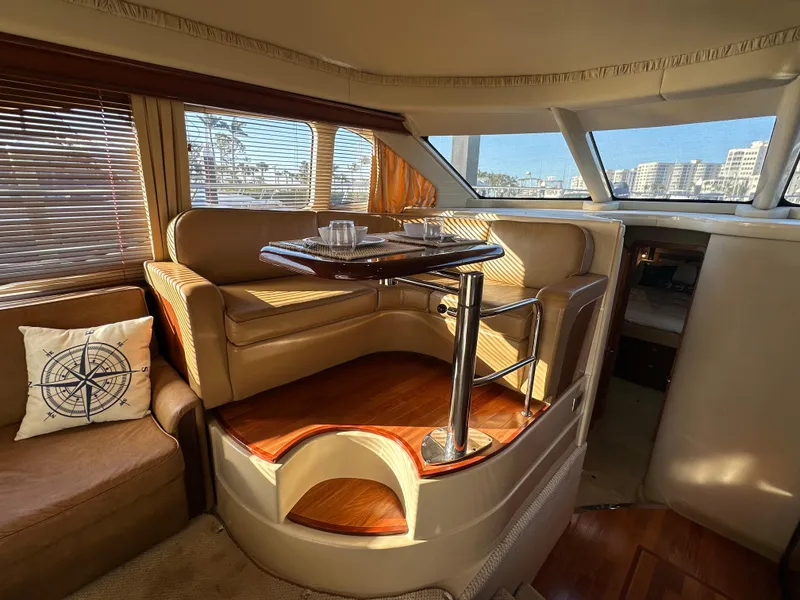 Slide: The Image of Luxurious interior of 2005 Sea Ray 420 Sedan Bridge yacht with elegant seating and dining area. - 15
