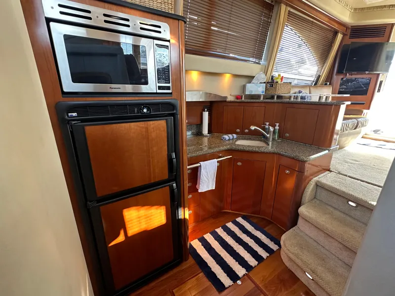 Slide: The Image of Interior of 2005 Sea Ray 420 Sedan Bridge yacht with kitchen and stairs. - 16