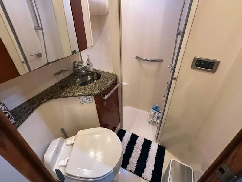 Slide: The Image of Bathroom interior of 2005 Sea Ray 420 Sedan Bridge with shower, sink, and toilet. - 23