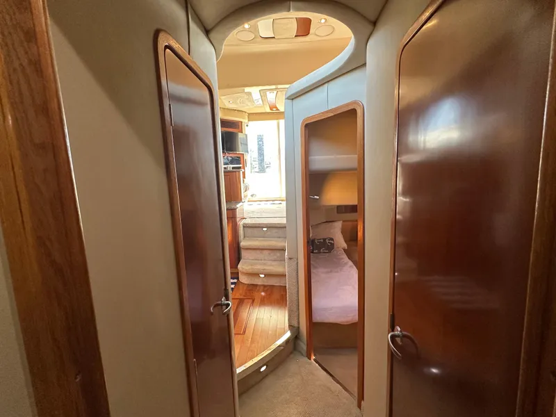 Slide: The Image of Interior view of 2005 Sea Ray 420 Sedan Bridge, featuring cozy cabin and wooden finishes. - 24