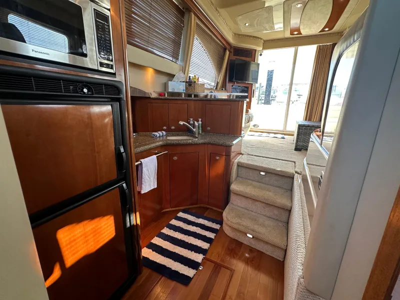 Slide: The Image of Interior of 2005 Sea Ray 420 Sedan Bridge yacht with kitchen and stairs. - 25