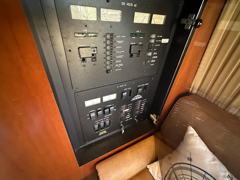 Slide: The Image of Electrical panel inside 2005 Sea Ray 420 Sedan Bridge yacht, featuring switches and controls. - 29