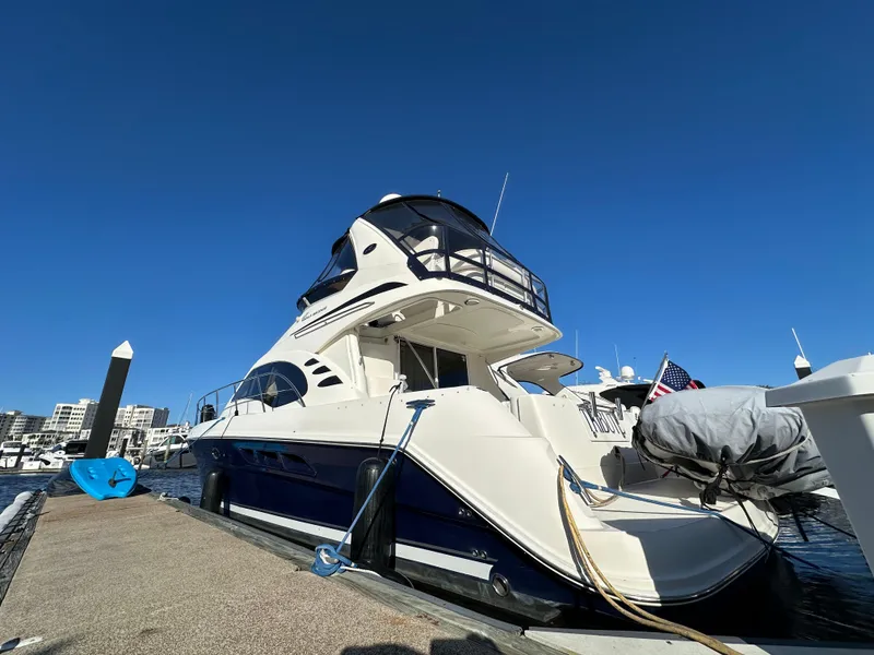 Slide: The Image of 2005 Sea Ray 420 Sedan Bridge yacht docked at marina under clear blue sky. - 3