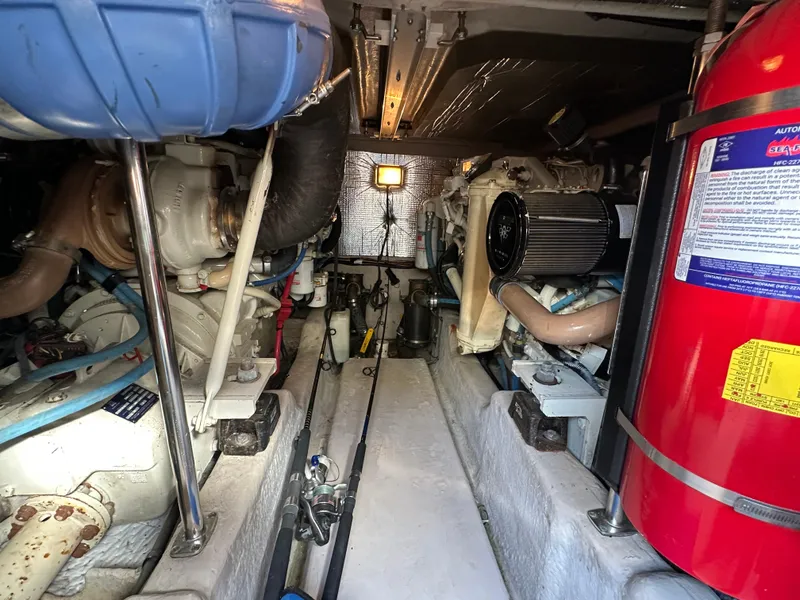 Slide: The Image of Engine room of 2005 Sea Ray 420 Sedan Bridge, featuring mechanical components and fire extinguisher. - 31