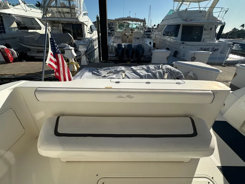 Slide: The Image of 2005 Sea Ray 420 Sedan Bridge yacht at marina, featuring rear seating and American flag. - 6
