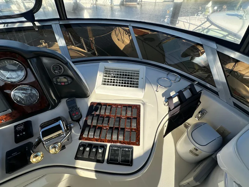 Slide: The Image of Cockpit of 2005 Sea Ray 420 Sedan Bridge with control panel and navigation instruments. - 9